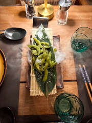 beautiful table setting for with a fog a dinner with vegetables, edamame
