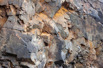 Close-up of a rugged, weathered rock formation with cracks.