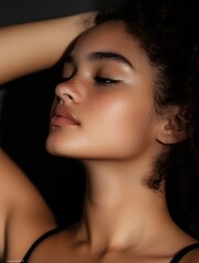 Obraz premium Elegant profile of a woman with curly hair showcasing natural beauty and smooth skin in soft light : Generative AI