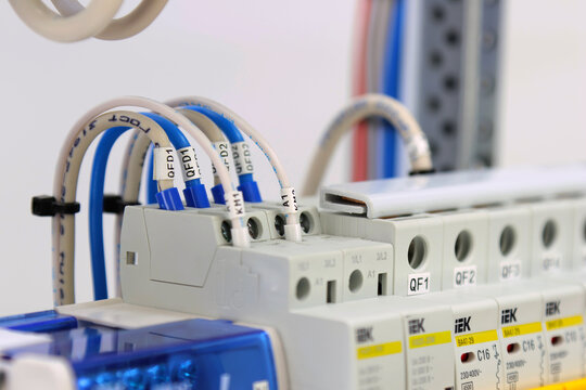 Automatic current switches from the IEK company on a dinreak in an electric panel.