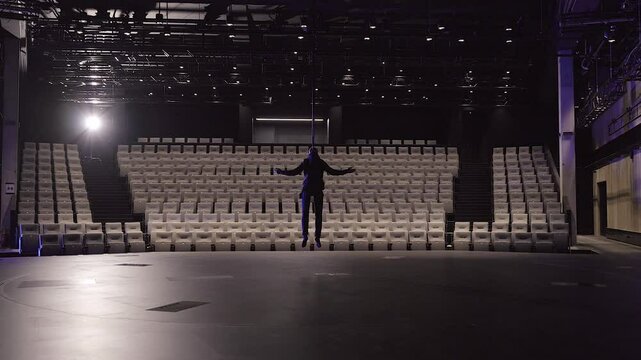 A Man Is Lifted Above the Stage in an Empty Theater Hall Without an Audience. During Theatrical Performances, it is Possible to Lift Actors. This Gives More Opportunities for Creative Expression.