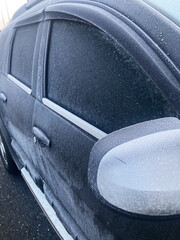Close-up car door frozen due to cold