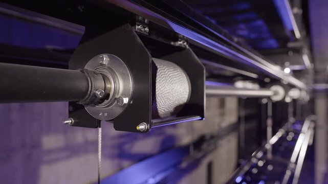 Metal Cable Rolls Out from a Hoist Spool. Stage Truss in the Background. Lighting or Stage Truss Allows Lighting Designers the Freedom to Hang LED or Automated Fixtures, Where Ever they Choose.