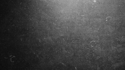 A black and white photo of a wall with a greyish texture. The wall appears to be made of concrete and has a rough surface