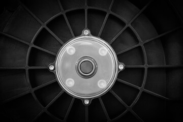 Shaft seat with bearing in black metal case covered with white metal plate, industrial concept background.
