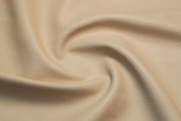 beige artificial leather with waves and folds on PVC base