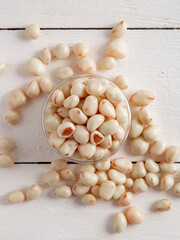 Dried fruits in white milk chocolate. Candies on a wooden background.