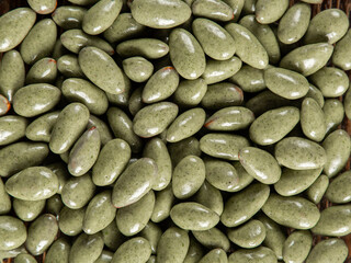 Candies with green chocolate glaze. Background, texture, lots of sweets.