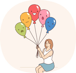 Emotional control is practiced by woman holding balloons with positive or negative grimace. Girl uses emotional control methods to avoid mood swings or mental burnout caused by regular stress