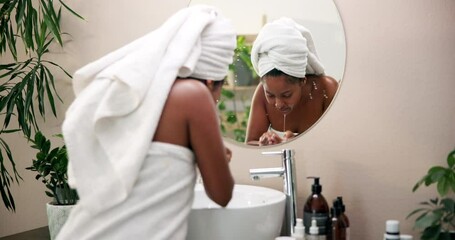 Skincare, woman and washing face in home mirror for morning routine, skin hydration and deep cleansing. Reflection, person and water for cleaning bacteria, dirt removal and beauty glow with towel - Powered by Adobe