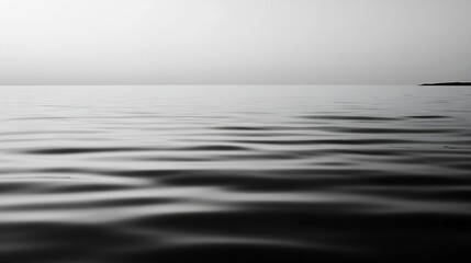 Minimalist black and white image of calm water surface reflecting an overcast sky : Generative AI © Generative AI