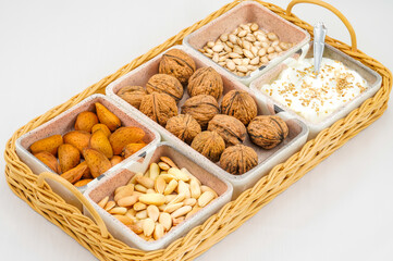 Tray with almonds, walnuts, pumpkin seeds and yoghurt
