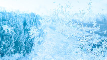 Winter frost patterns on glass. Ice crystals or cold winter background.