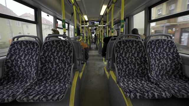 Germany, Berlin. Municipal bus BVG, Berliner Verkehrsbetriebe view from inside from passenger seat. Interior of yellow city bus on route in Berlin. Public transportation in Germany. 