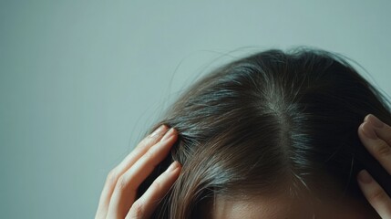 Fototapeta premium Hair loss displayed in a person brushing their thinning hair in a minimalist bedroom. Featuring care and nourishment