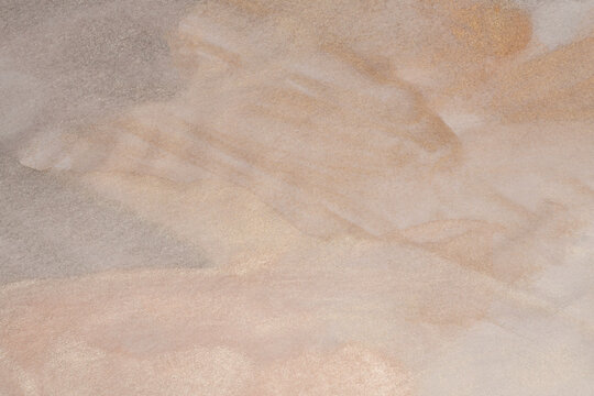 Metallic Ink watercolor grain pour blot on beige empty paper blank texture background. Silver, nacre, gold, beige neutral tone.