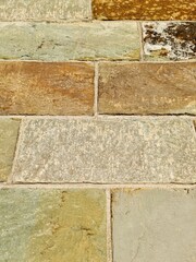 Colorful stone wall showing different textures and colors creating an intriguing pattern