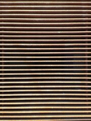 Rusty metal grille creating repeating horizontal lines