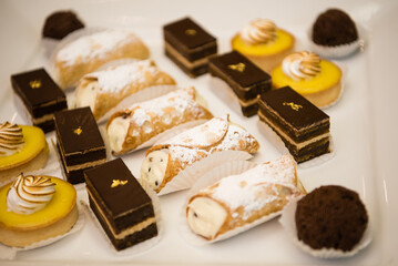 Arrangement of chocolate sweet treats and cannolis. 