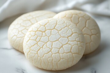 Three textured white buns on marble, table setting