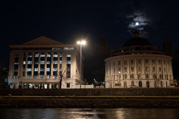 The headquarters of Water Supply and Sewerage Skopje illuminated at night. This modern building serves as the main office for the city's water management services.