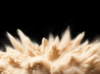Beige powder exploding against black background creating a dynamic shape