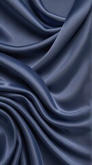 Fototapeta premium Deep blue satin fabric with smooth, elegant folds. Luxurious, flowing texture perfect for backgrounds, fashion, or sophisticated design projects.