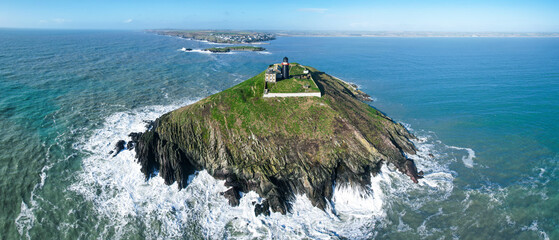 Aerial view of Ballycotton Lighthouse on Ballycotton Island, County Cork, Ireland, a historic black-painted lighthouse overlooking the Atlantic Ocean