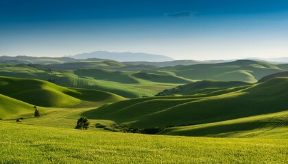 rolling green hills extend across the landscape under a clear sky