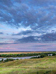 Obraz premium Beautiful landscape with a river and a sky full of clouds