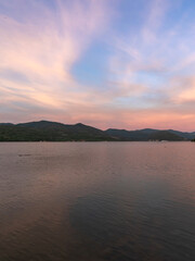 Beautiful sunset over a lake with mountains in the background