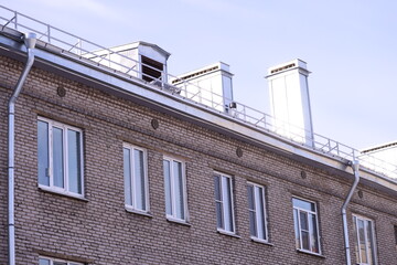 A classic brick building with a clock tower, suitable for use in a scene depicting nostalgia or old-world charm.
