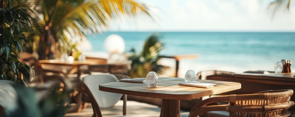 Fototapeta premium Seaside cafe with wooden tables overlooking tropical beach and ocean scenery