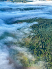 A beautiful sunrise in the sky over the morning fog. View from a hot air balloon. Europe