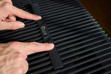 Hands adjusting a modern appliances control panel for optimal functionality and home comfort