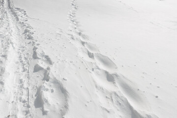 old snow covered footsteps in a snowy landscape