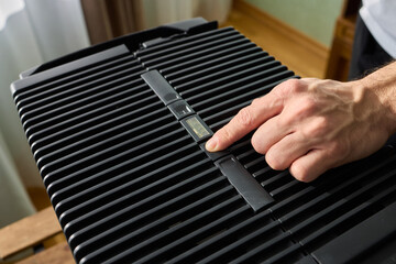 Hands adjusting a modern appliances control panel for optimal functionality and home comfort