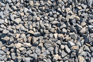 Pile of crushed gray stones for construction