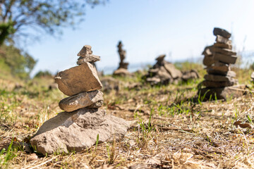 Stone towers piled up by traveling tourists in a natural environment