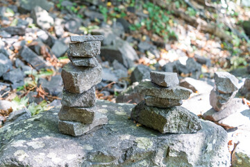Stone towers piled up by traveling tourists in a natural environment