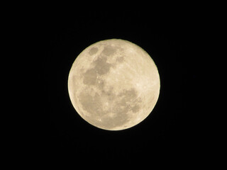 A beautiful full moon on a dark night in a country town