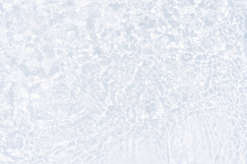 Obraz premium White water with ripples on the surface. Defocus blurred transparent white colored clear calm water surface texture with splashes and bubbles. Water waves with shining pattern texture background.