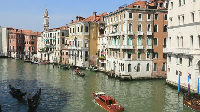 Le grand canal bord&eacute; d'immeubles et encombr&eacute; des typiques gondoles de Venise.