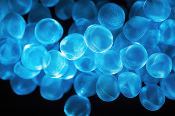 Glowing blue spheres create a mesmerizing, ethereal atmosphere with their luminescent quality against a dark background, evoking a sense of mystery and fluidity.