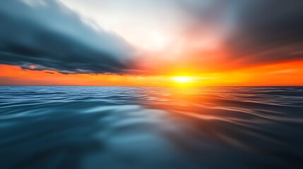 Obraz premium Serene sunset over calm ocean waters with dramatic clouds reflecting vibrant colors