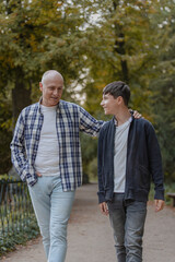 Father and son walking in the field, talking