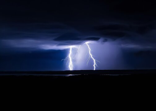 Two bright lightning bolts at night with rain