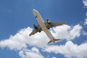 A plane soaring through the sky, symbolizing a journey of hope and new possibilities, with a clear blue backdrop.
