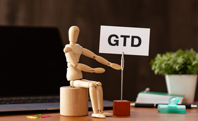 There is word card with the word GTD. It is an abbreviation for Getting Things Done as eye-catching...