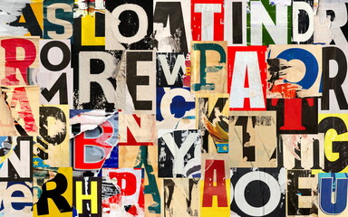 Collage of many different lacerated letters ripped torn advertisement street posters grunge creased...